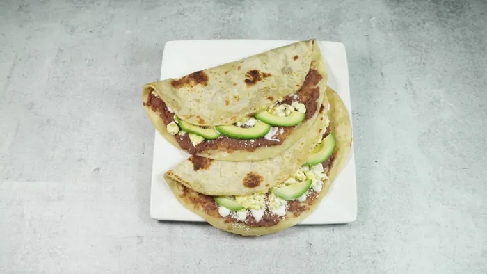 Baleadas: folded flour tortillas with beans, cheese and avocado