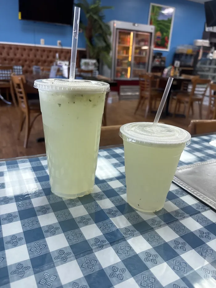 Two cups of lemonade on a gingham tablecloth
