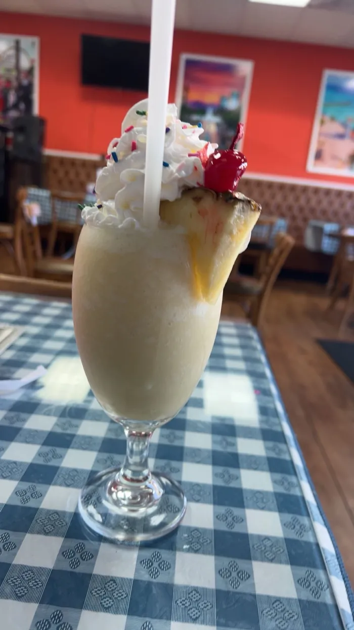 Piña colada with whipped cream and a cherry